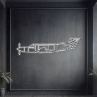 Pilatus PC‑12 single-engine turboprop neon silhouette wall art, laser‑cut steel with glowing neon outline and striking 3D elevation